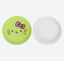 Load image into Gallery viewer, Indulge your lips with The Crème Shop x Hello Kitty Macaron Lip Balm. Infused with Shea Butter and Vitamin E, it delivers a smooth and moisturizing experience. Repair your pout with its blend of 3 natural oils, while enjoying the irresistible Juicy Pear flavor. Made in Korea, paraben and sulfate-free. the best price and quality w/ bonitawholesale.com

